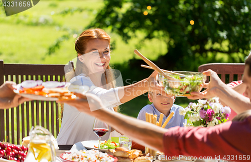 Image of happy family having dinner or summer garden party