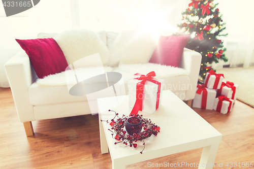 Image of close up of christmas gift box on table at home