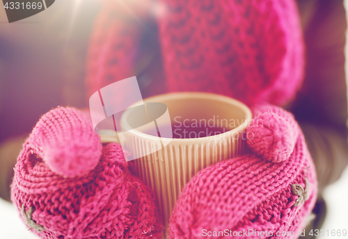 Image of close up of woman with tea mug outdoors in winter