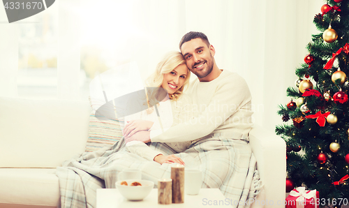 Image of happy couple at home with christmas tree