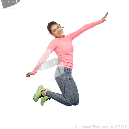 Image of happy smiling sporty young woman jumping in air