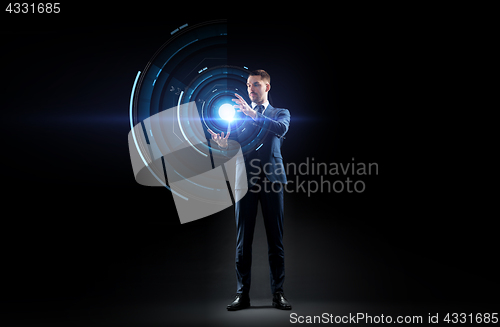 Image of businessman in suit with virtual projection