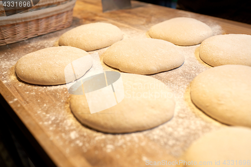 Image of yeast bread dough on bakery kitchen table