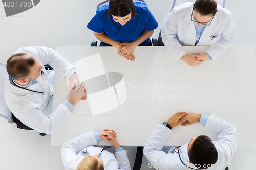 Image of group of doctors sitting at empty table