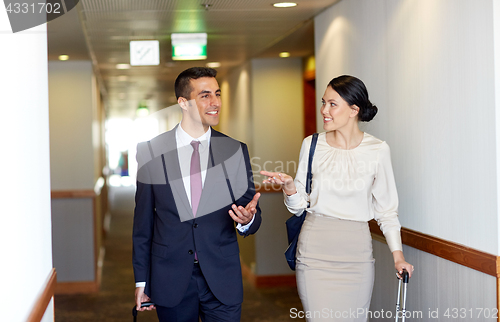 Image of business team with travel bags at hotel corridor