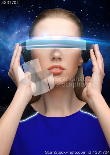 Image of woman in virtual reality 3d glasses over black