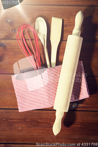 Image of close up of kitchenware for baking on wooden board