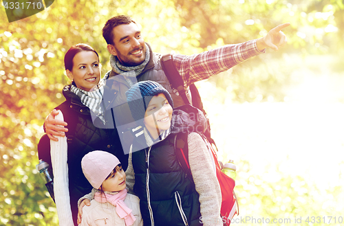 Image of happy family with backpacks hiking