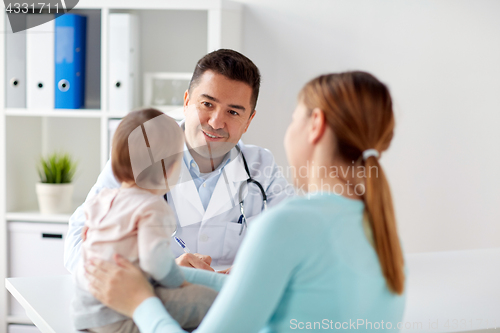 Image of happy woman with baby and doctor at clinic