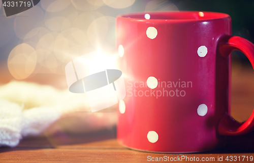 Image of red polka dot tea cup on wooden table