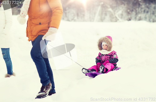 Image of happy family with sled walking in winter forest