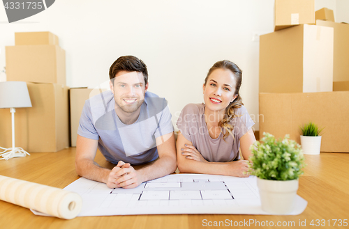 Image of couple with boxes and blueprint moving to new home
