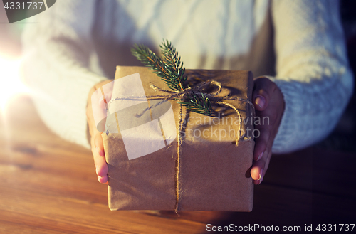 Image of close up of woman with christmas gift or parcel