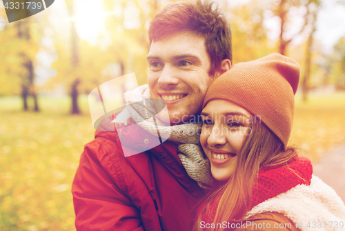 Image of happy young couple walking in autumn park