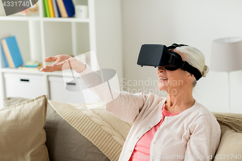 Image of old woman in virtual reality headset or 3d glasses