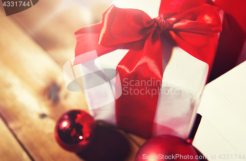 Image of close up of gift boxes and red christmas balls