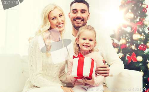 Image of happy family at home with christmas gift box