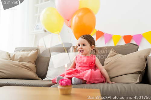 Image of happy baby girl on birthday party at home