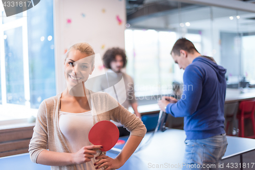 Image of startup business team playing ping pong tennis