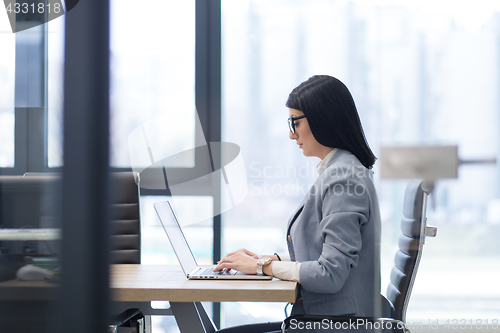 Image of businesswoman using a laptop in startup office