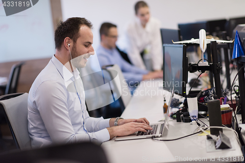 Image of businessman working using a laptop in startup office