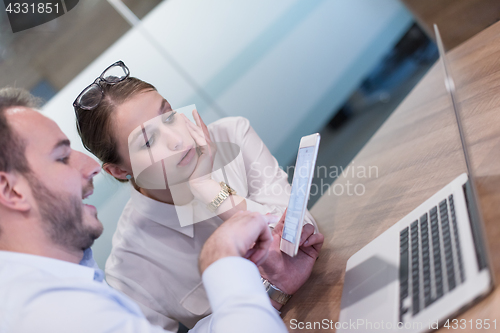 Image of Business People Working With Tablet in startup office