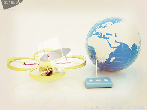 Image of Quadrocopter Drone with Earth Globe and remote controller on a w