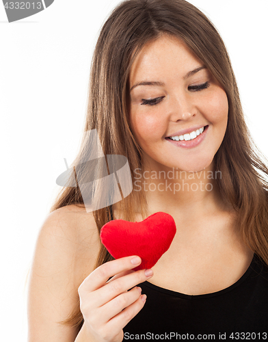 Image of young woman in love with a heart in hand