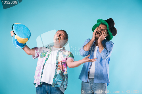 Image of The two football fans over blue