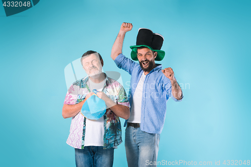 Image of The two football fans over blue