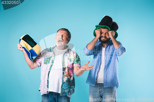 Image of The two football fans over blue