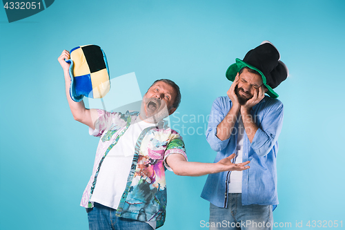 Image of The two football fans over blue