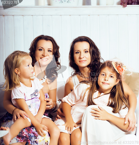 Image of Mature sisters twins at home with little daughter, happy family