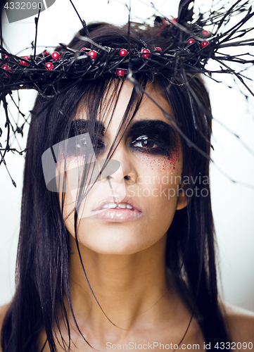 Image of pretty brunette woman with make up like demon at halloween, clos