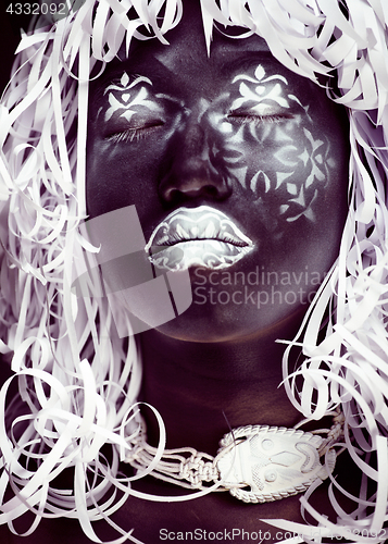 Image of creative makeup like Ethiopian mask, white pattern on black face