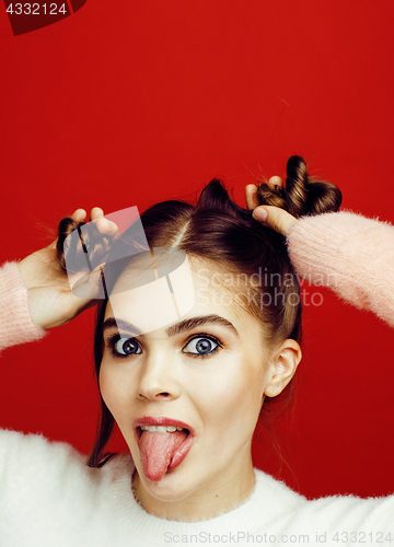 Image of young pretty emitonal posing teenage girl on bright red backgrou