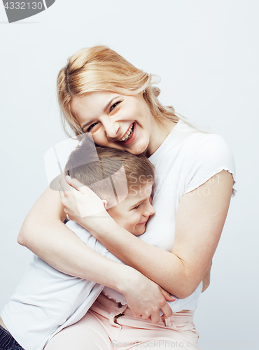 Image of young modern blond curly mother with cute son together happy smiling family posing cheerful on white background, lifestyle people concept, sister and brother friends 