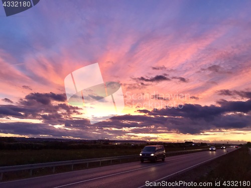 Image of Cars driving during dramatic sunset