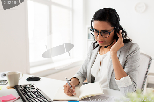 Image of businesswoman with headset talking at office