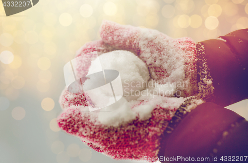 Image of close up of woman holding snowball outdoors