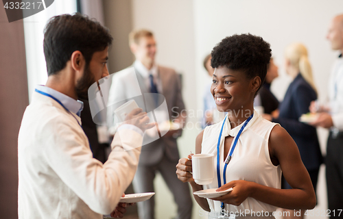 Image of business people with conference badges and coffee