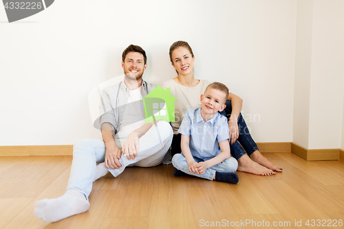 Image of happy family with green house moving to new home