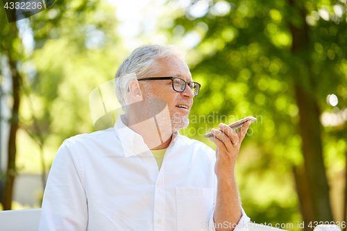 Image of old man using voice command recorder on smartphone