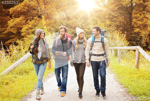 Image of friends hiking with backpacks and tablet pc