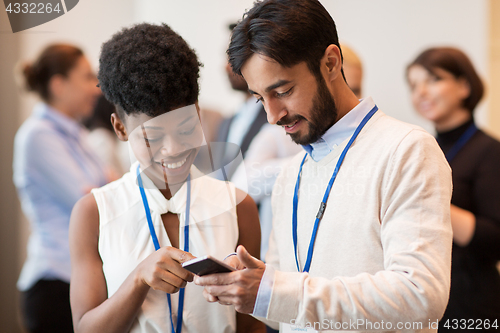 Image of couple with smartphone at business conference