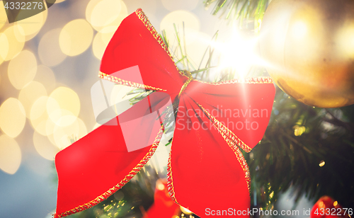Image of close up of red bow decoration on christmas tree