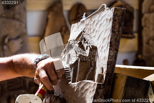 Image of Sculptor hands working wood