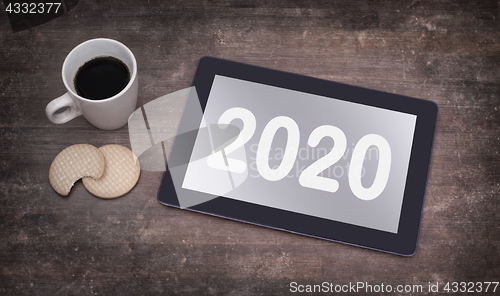 Image of Tablet touch computer gadget on wooden table - 2020