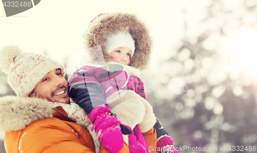 Image of happy family in winter clothes outdoors