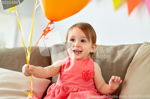 Image of happy baby girl on birthday party at home